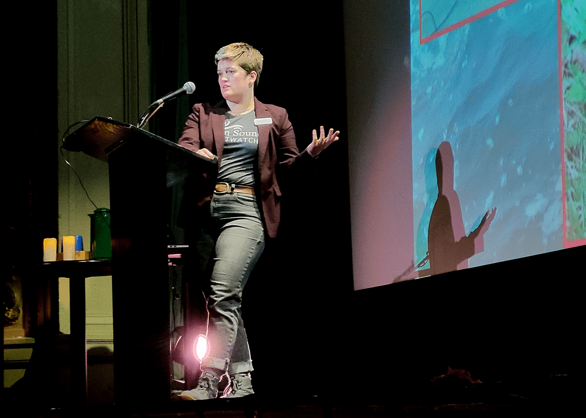 Maggy Tran giving a lecture at the Cabot Theatre in Beverly, MA