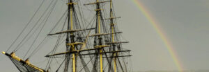 A rainbow on an overcast day above The Friendship in Salem, Massachusetts