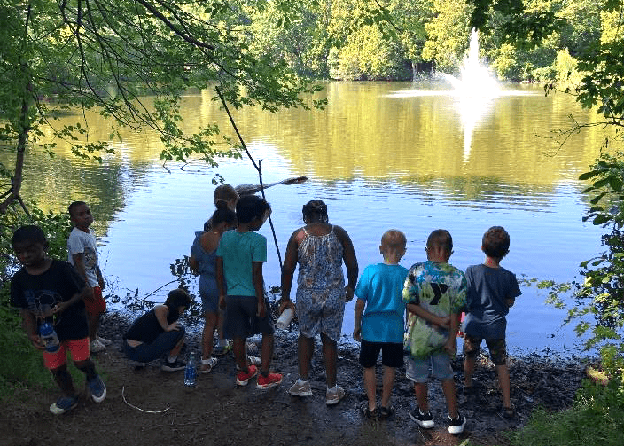 Kids standing by a river on a watershed walk in Salem, Massachusetts.