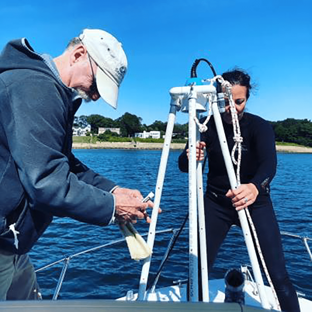 Citizen Scientists on a boat with tools used for monitoring eelgrass meadows in Salem Sound.