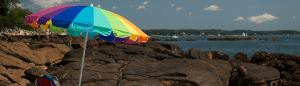 Umbrella and chair on the beach looking out at the ocean from Winter Island, Salem, Massachusetts.